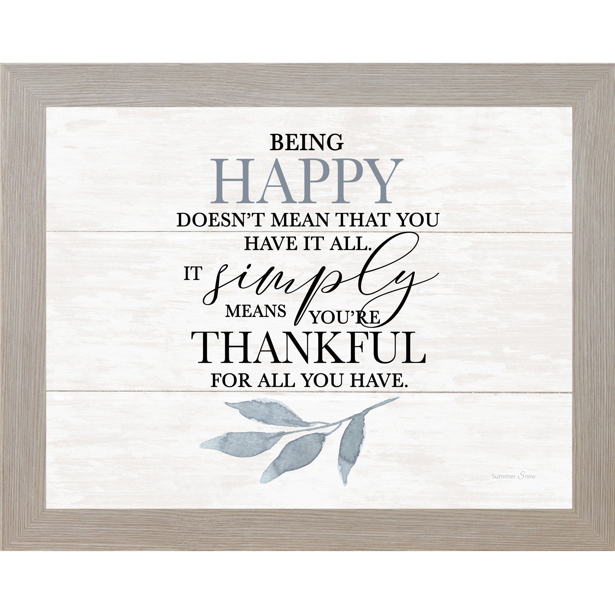 Framed wall art featuring the quote “Being happy doesn’t mean that you have it all, it simply means you’re thankful for all you have” on a white slatted wood background with soft blue leaves