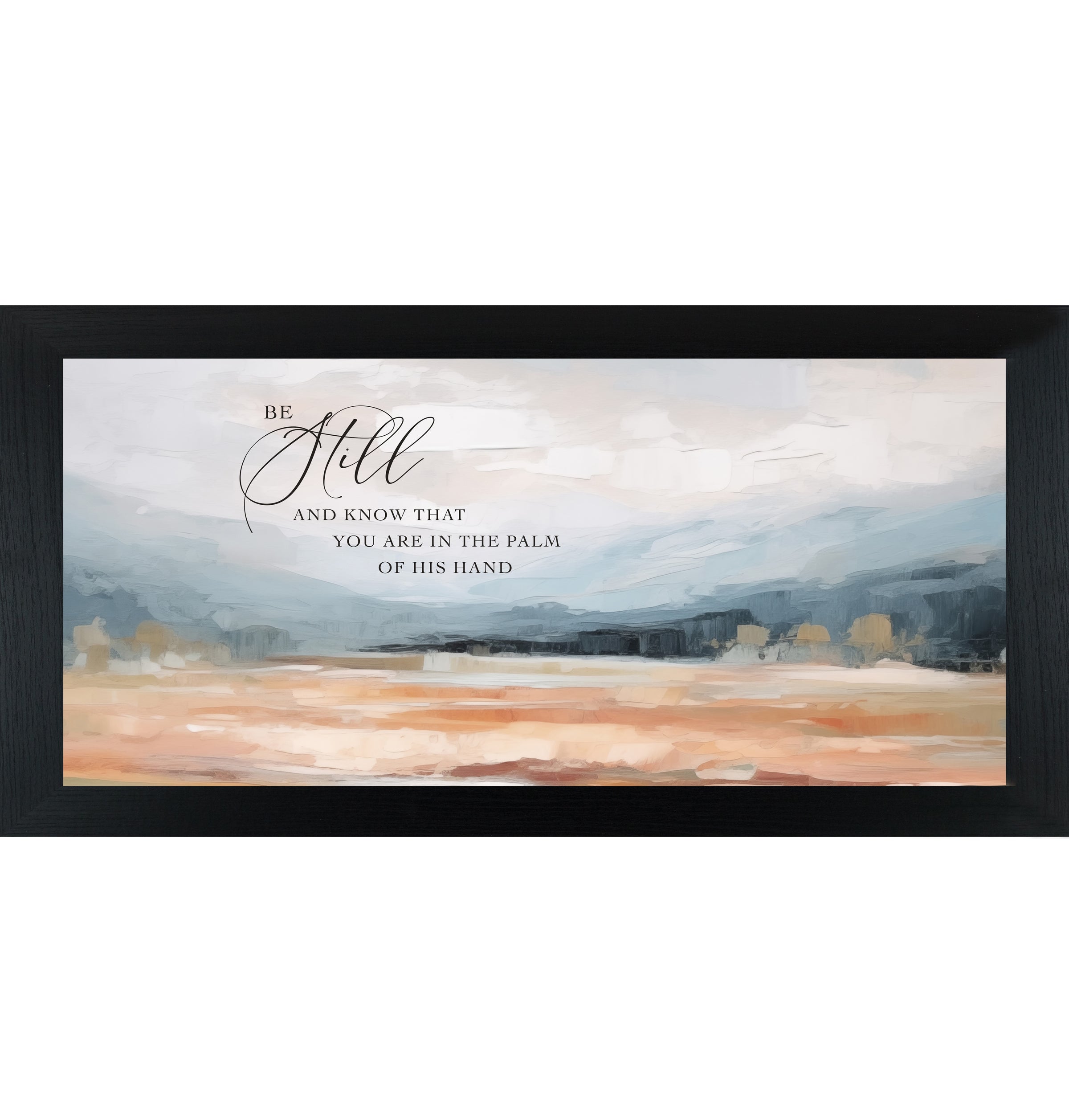 Black framed wide landscape Christian wall art with Be Still And Know That You Are In The Palm Of His Hand scripture in oversized script over dramatic blue-grey mountains and soft peach blush terracotta field