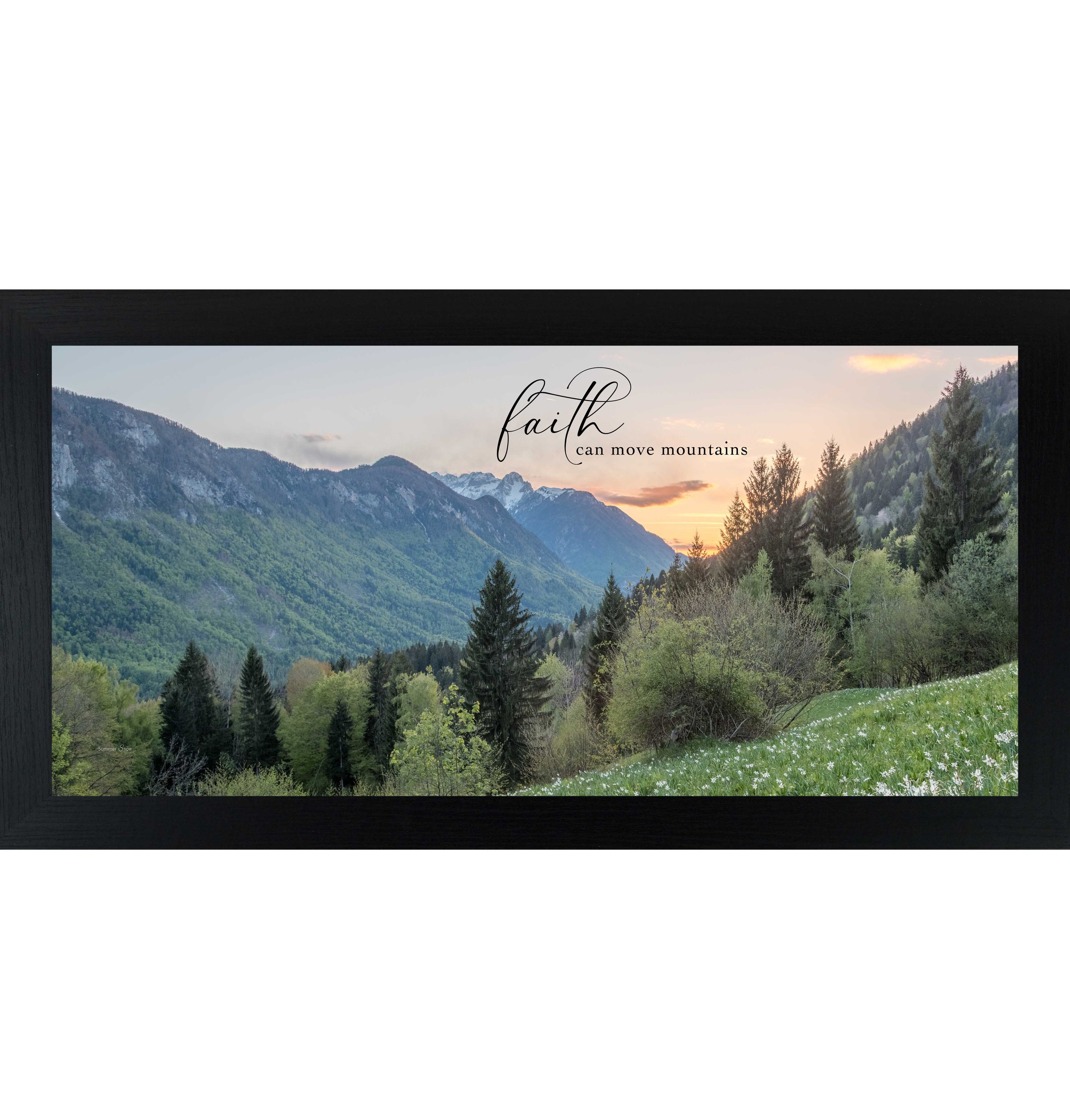 Black framed wide landscape inspirational wall art featuring mountain valley at sunrise with summer trees and wildflowers and the quote "Faith Can Move Mountains"