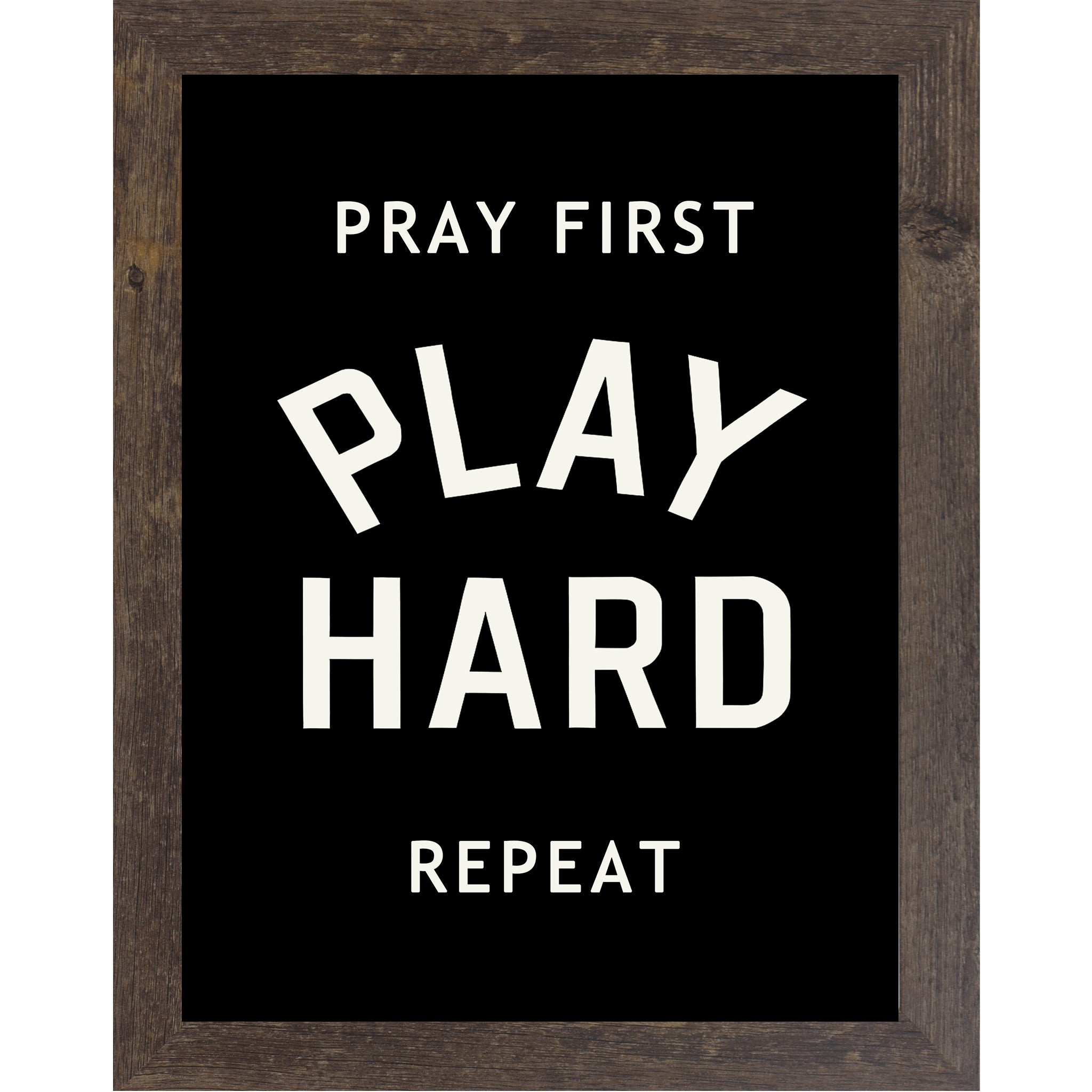 Natural Brown framed vertical Christian wall art featuring Pray First Play Hard Repeat in bold cream athletic varsity typography on a pure black background
