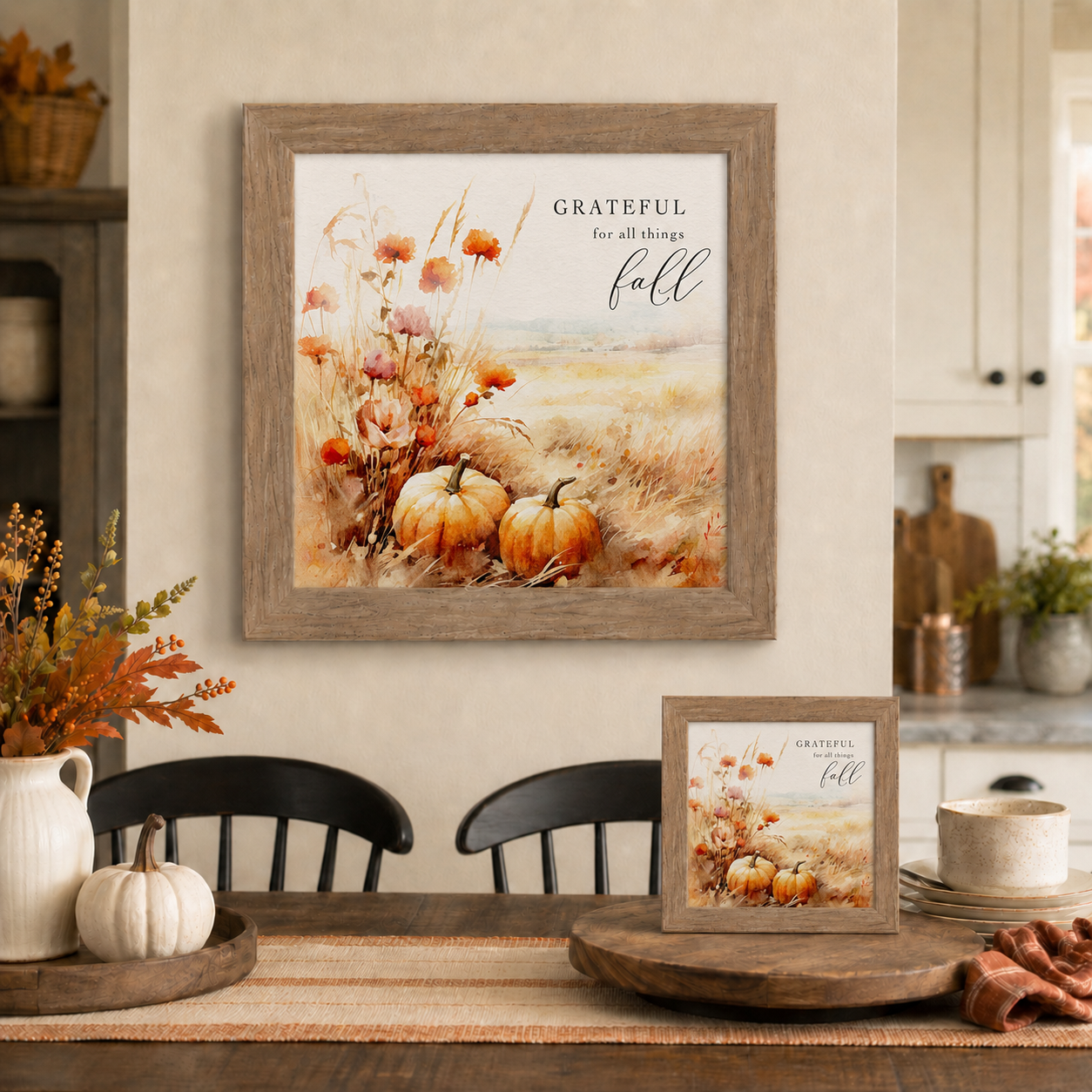 Farmtable framed Grateful for All Things Fall square fall wall art SN173 displayed large on farmhouse dining room wall above black chairs and wood table with 8x8 easel back on table beside white pumpkin dough bowl and fall berry branches — watercolor orange pumpkins red and pink wildflowers pampas grass and golden wheat field harvest scene