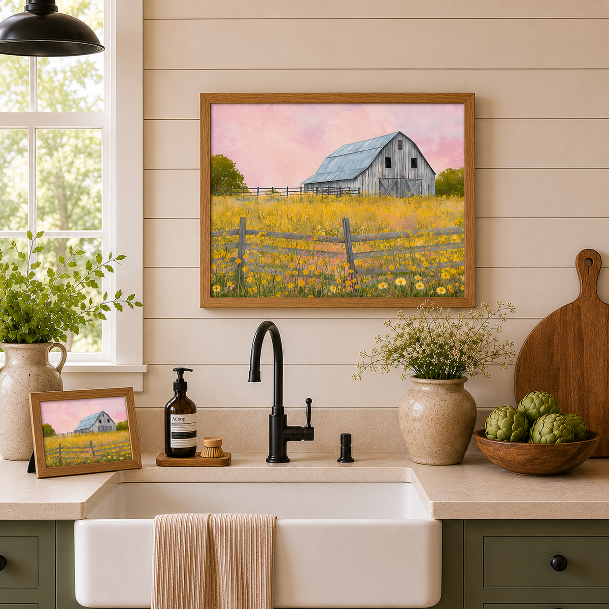 Farmhouse kitchen with Yellow Wildflower Barn wall art SB253 in natural brown frame — landscape hanging above farmhouse sink on shiplap wall and 10x8 easel back standing on the counter beside Aesop soap and cutting board