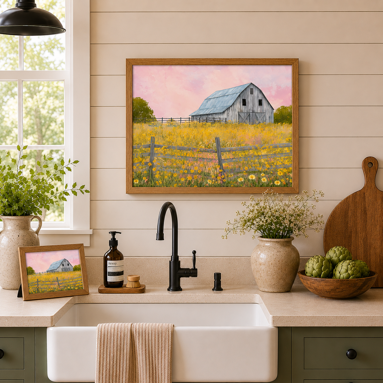 Farmhouse kitchen with Yellow Wildflower Barn wall art SB253 in natural brown frame — landscape hanging above farmhouse sink on shiplap wall and 10x8 easel back standing on the counter beside Aesop soap and cutting board