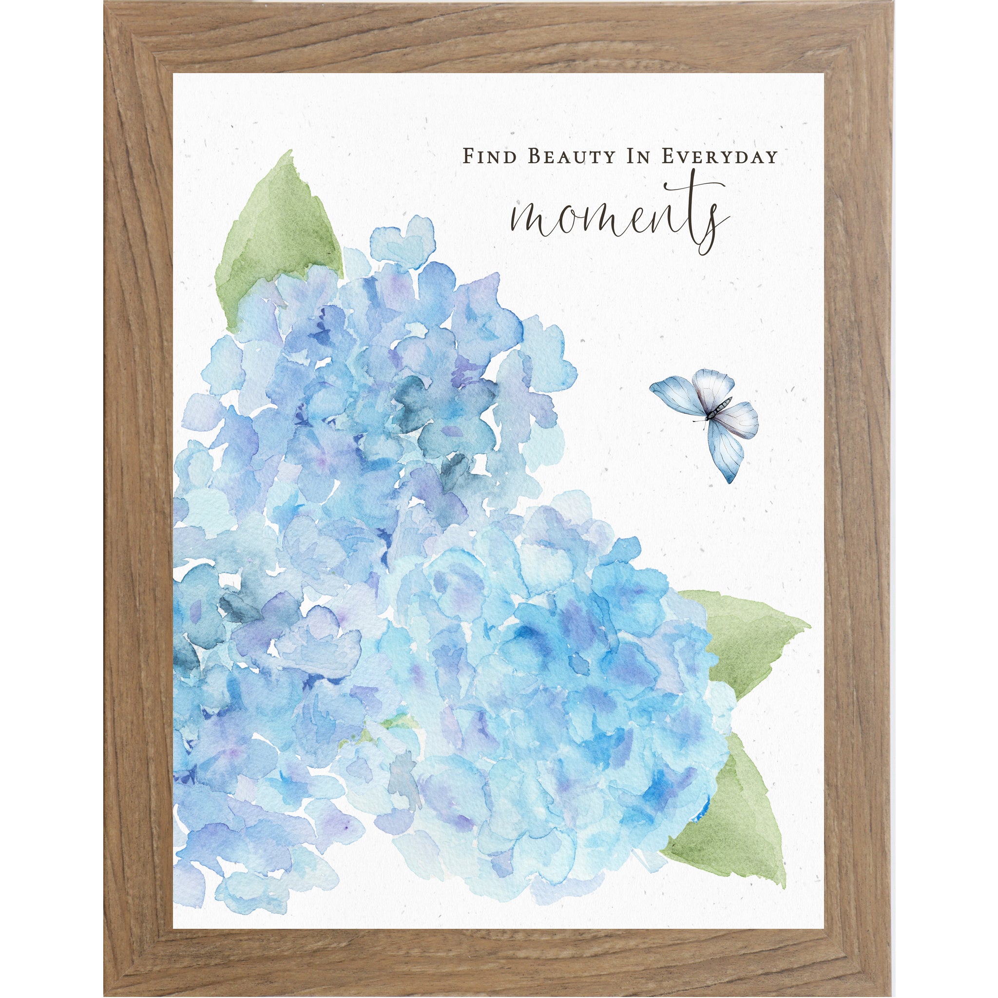 Farmtable Vertical blue hydrangea watercolor wall art with three large blooms, green leaves, butterfly, and quote Find Beauty in Everyday Moments.