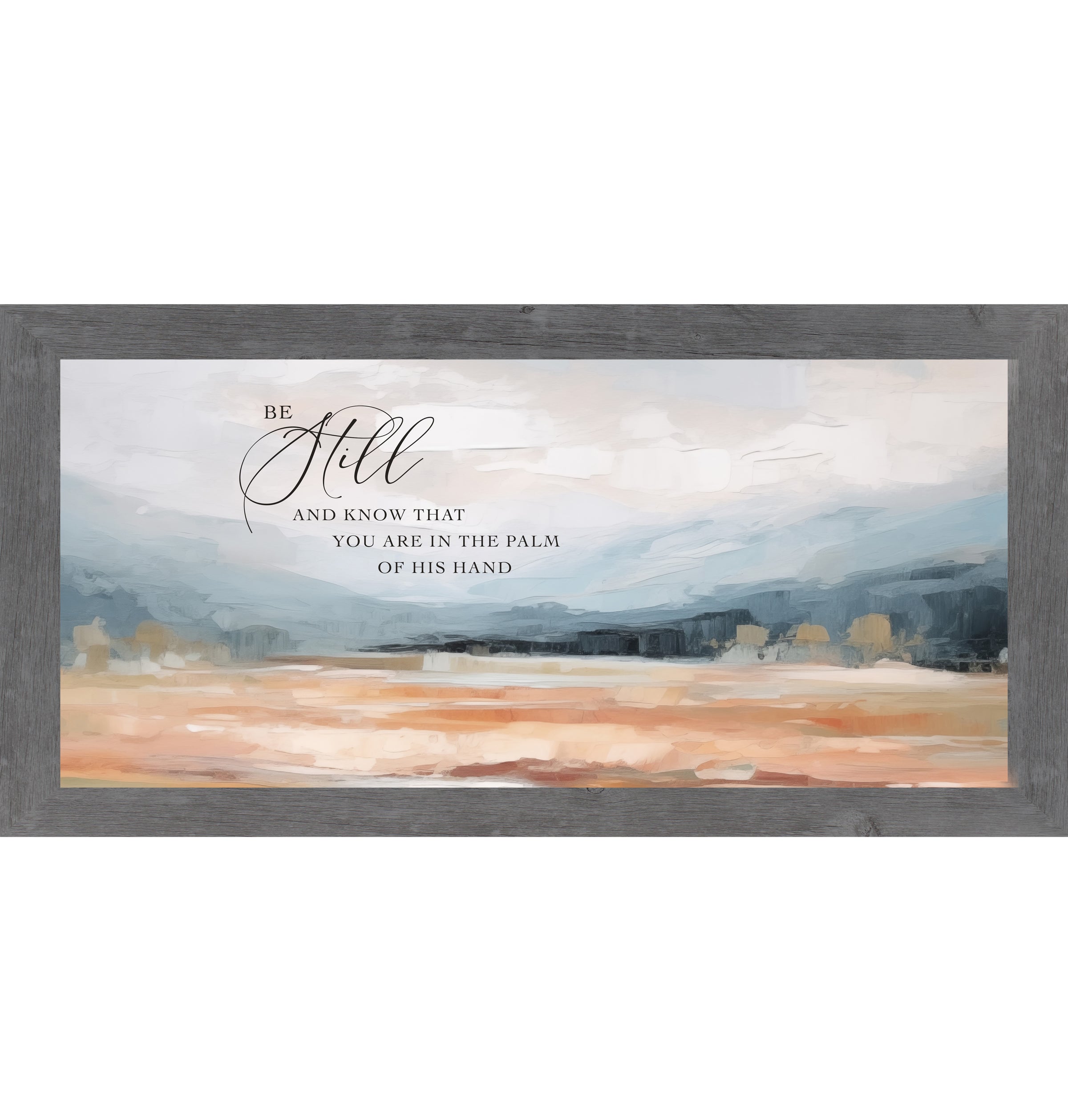 Gray framed wide landscape Christian wall art with Be Still And Know That You Are In The Palm Of His Hand scripture in oversized script over dramatic blue-grey mountains and soft peach blush terracotta field