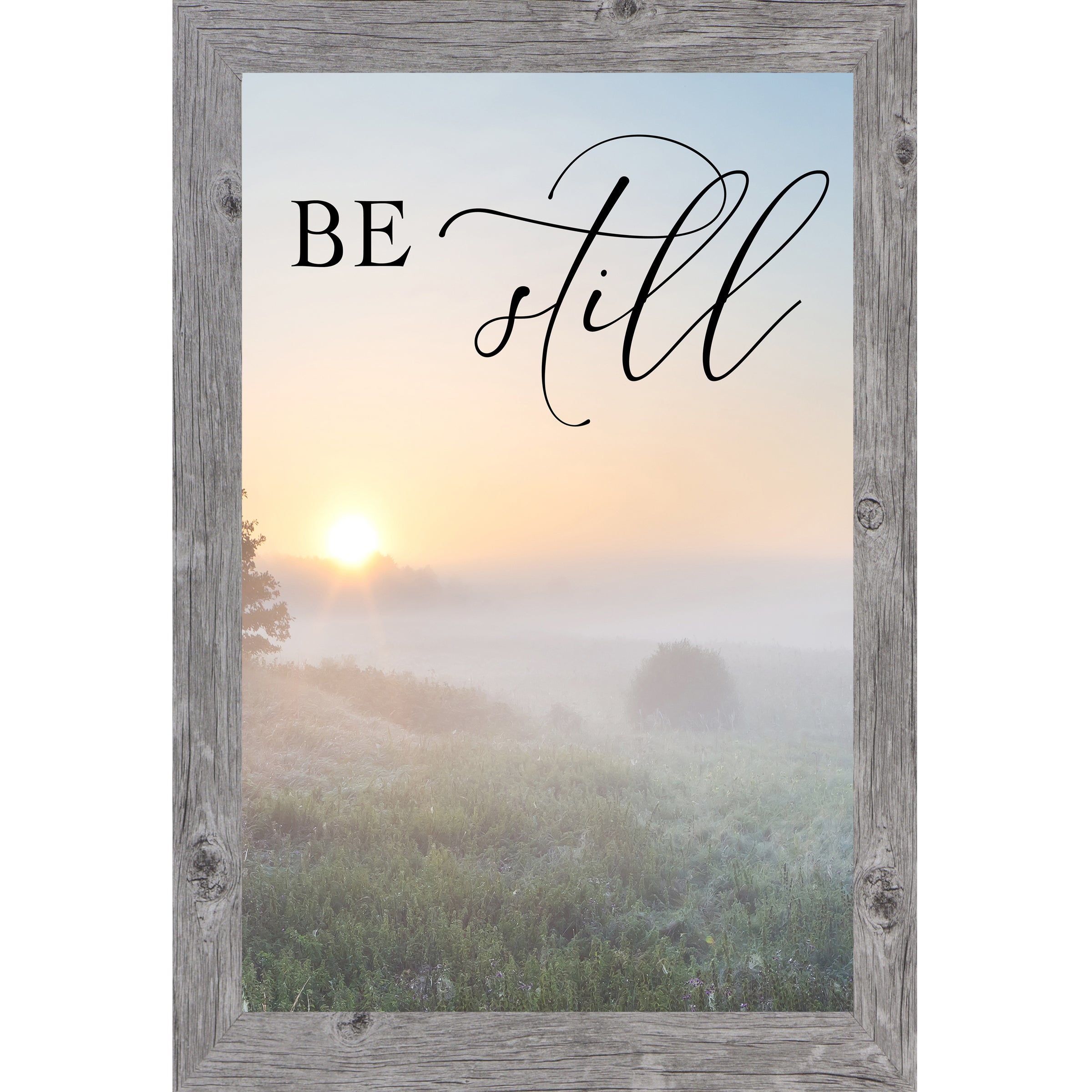 Gray framed tall portrait Christian scripture wall art with misty sunrise field ground fog silhouetted trees and the words "Be Still" Psalm 46:10 — 27x40 inches