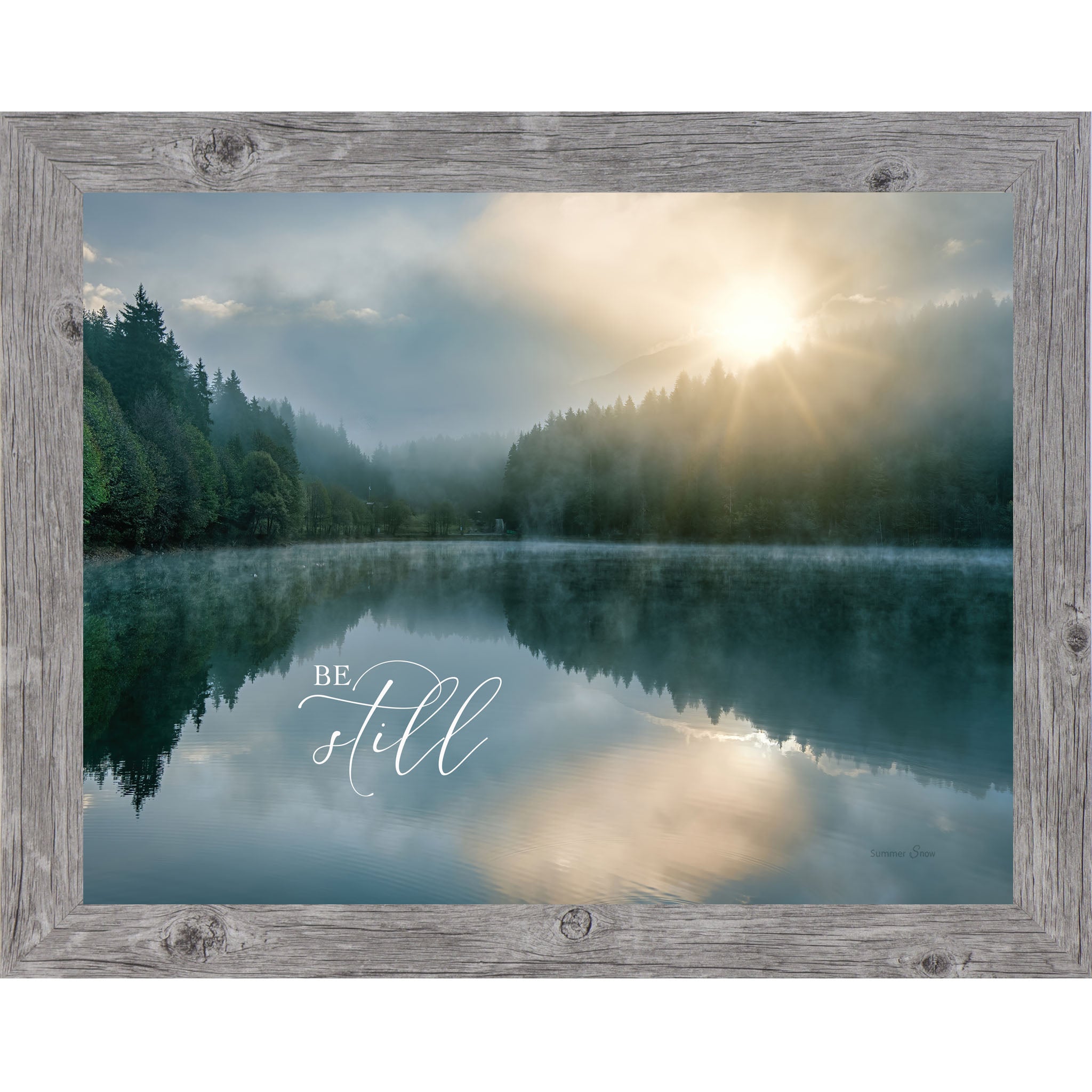 Gray framed landscape Christian wall art with realistic lake reflection of trees and sunrise with the words "Be Still" reflected in the water Psalm 46:10