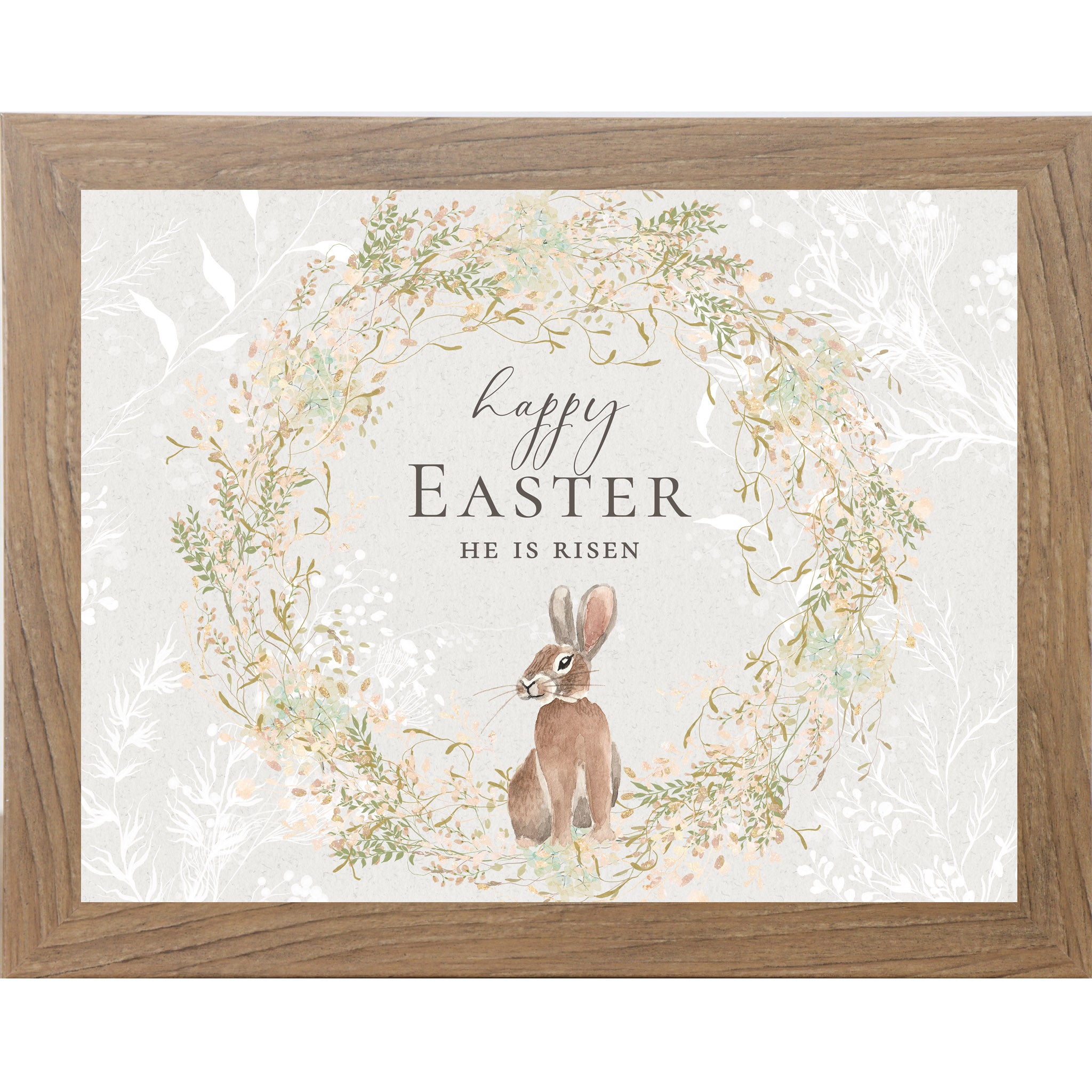 Watercolor Easter wall art featuring a bunny inside a floral wreath with the words Happy Easter He Is Risen on a soft neutral background.