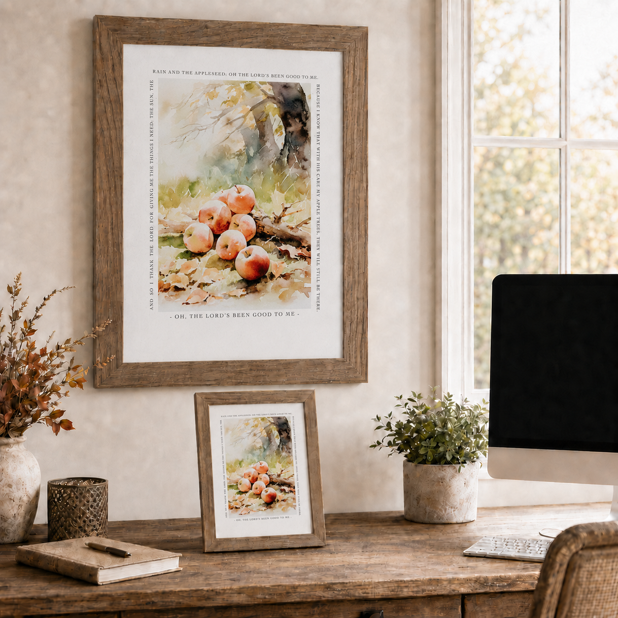 Farmtable framed Oh The Lord's Been Good To Me Johnny Appleseed prayer wall art SN396 displayed large on home office wall beside window with fall view — fall branches in vase and 8x10 easel back on wood desk — watercolor red apples under autumn tree on golden fall leaves surrounded by complete Johnny Appleseed prayer border