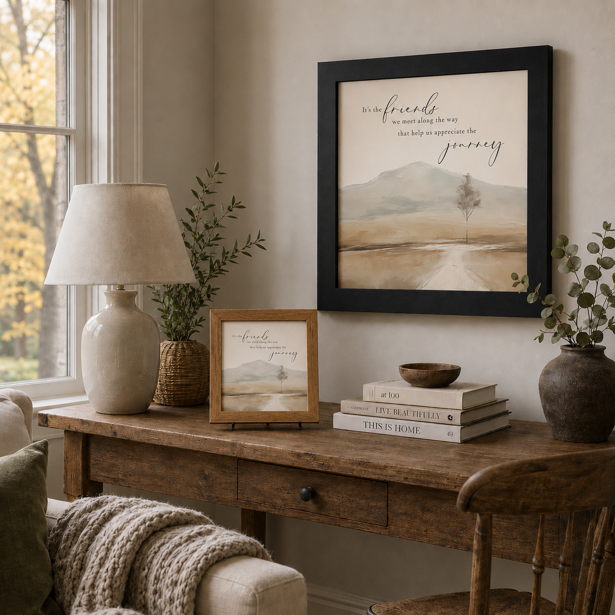 Farmhouse home office with It's the Friends We Meet Along the Way wall art SN127 — black 20x20 framed on the wall and farmtable 8x8 with easel back on the wooden desk beside a lamp and greenery