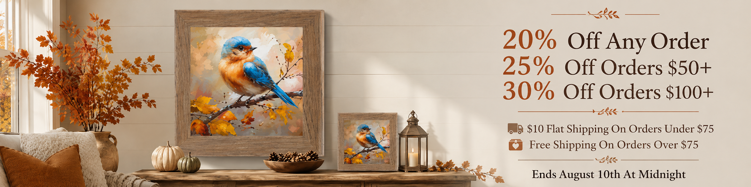 A framed art print featuring a bluebird perched on a branch with warm autumn foliage, shown in a styled interior scene alongside smaller matching framed prints, a lantern, pumpkins, and promotional text offering discounts on orders.