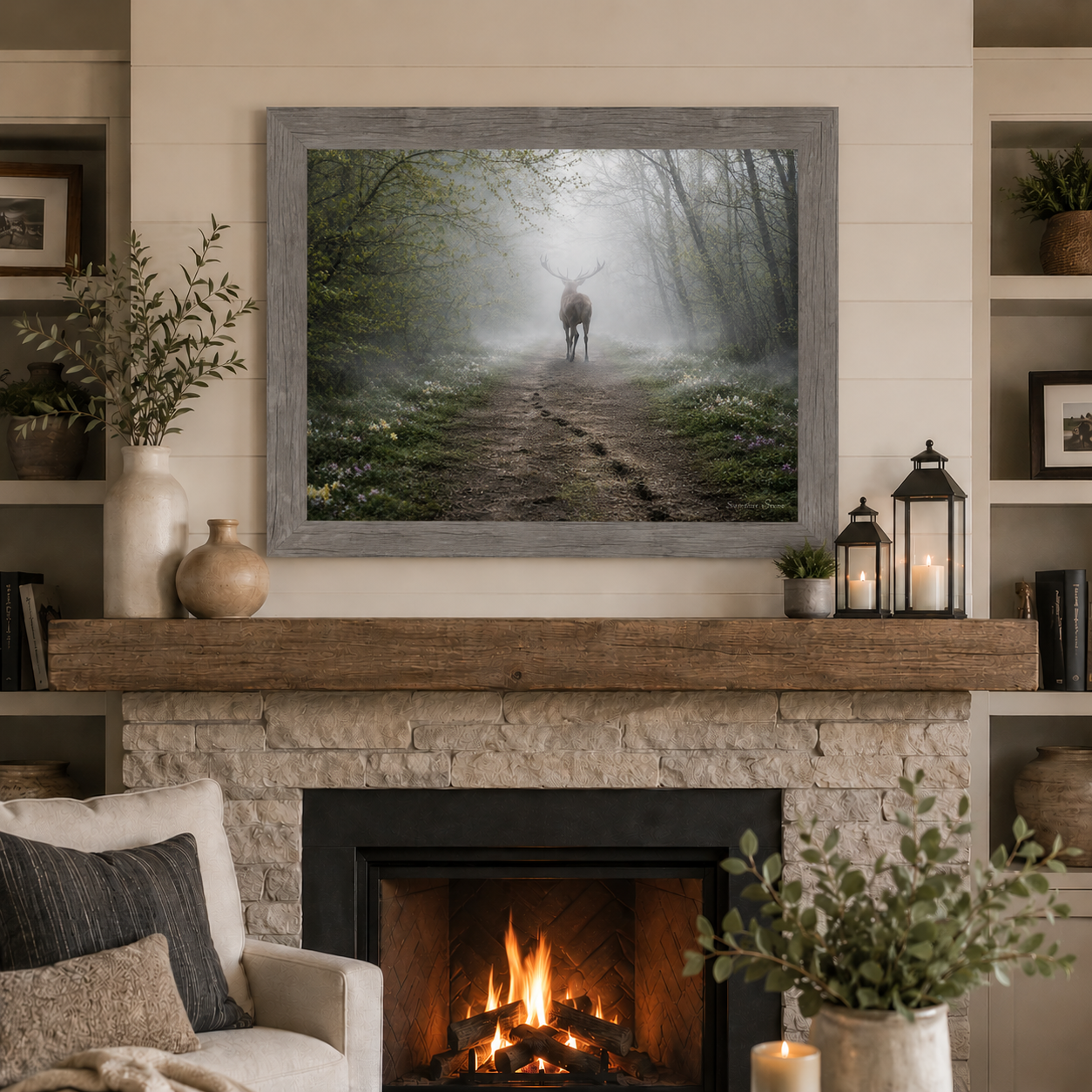 Gray framed horizontal ethereal misty deer forest path wall art featuring a deer silhouette dissolving into morning fog displayed as a large 32x26 statement piece above a stone fireplace mantle in a modern rustic living room with raw wood beam lanterns and shiplap walls