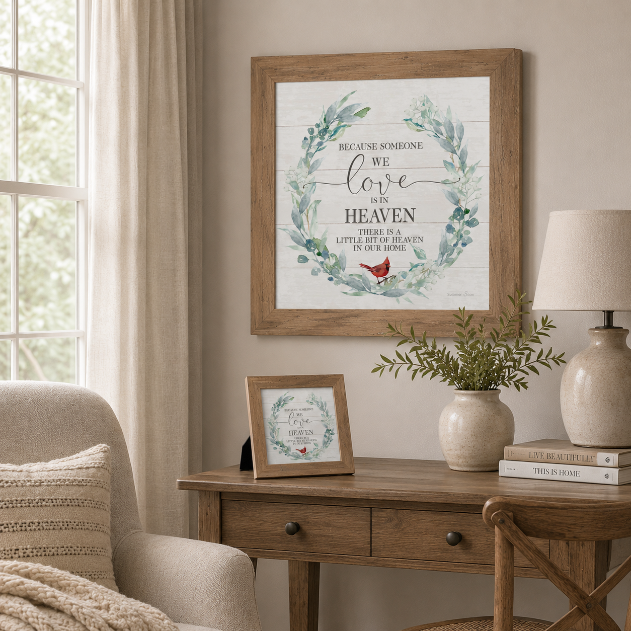 Soft neutral living room with Because Someone We Love Is in Heaven wall art SS822 in natural brown frame — 20x20 hanging on wall and 8x8 easel back standing on wooden desk beside greenery lamp and Live Beautifully books