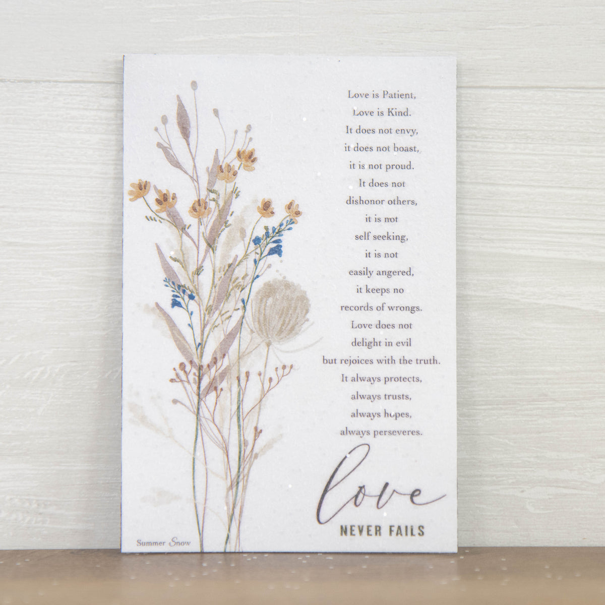 Christian scripture magnet featuring 1 Corinthians 13 Love Is Patient Love Is Kind verse with floral accent on neutral background, vertical faith decor with subtle glitter finish