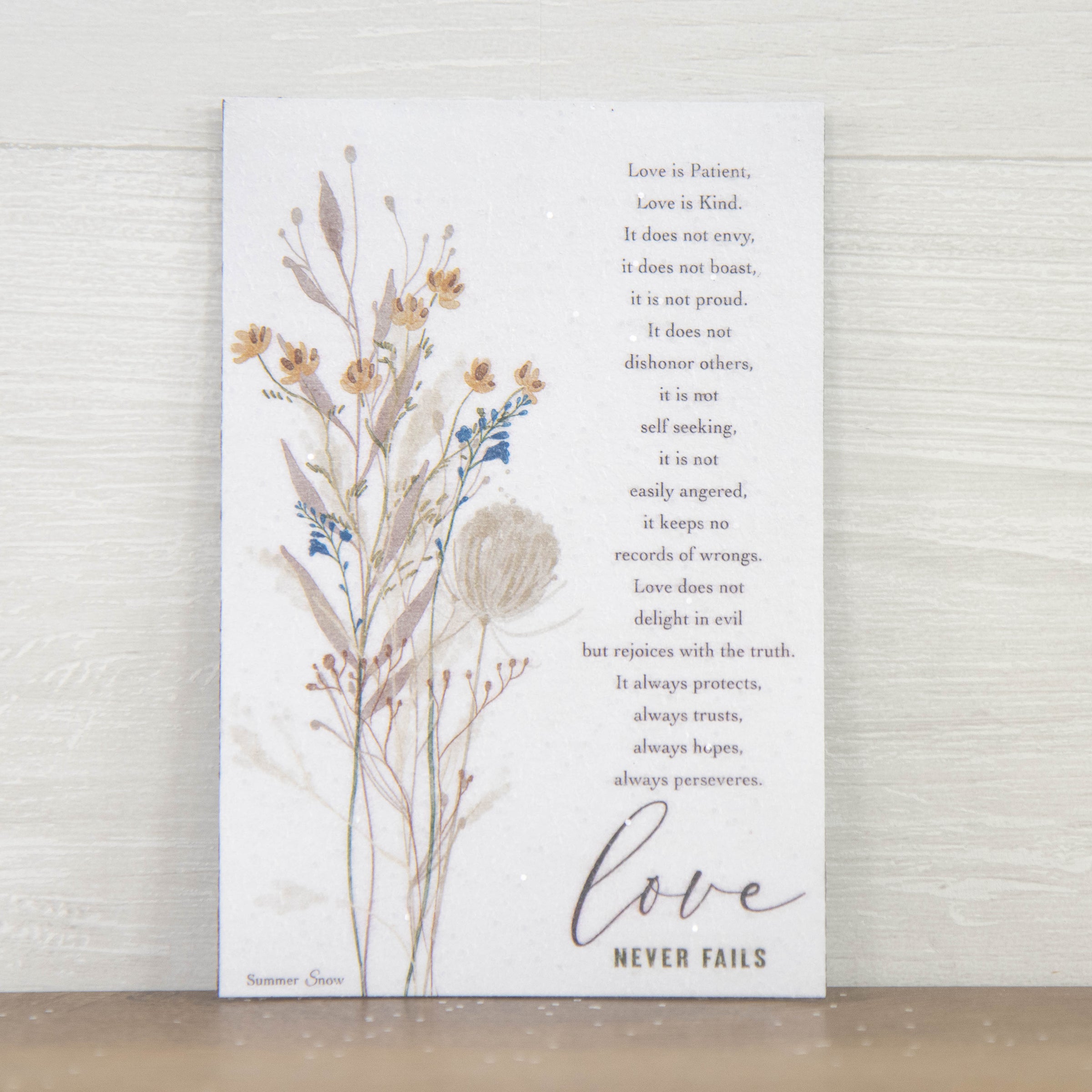 Christian scripture magnet featuring 1 Corinthians 13 Love Is Patient Love Is Kind verse with floral accent on neutral background, vertical faith decor with subtle glitter finish