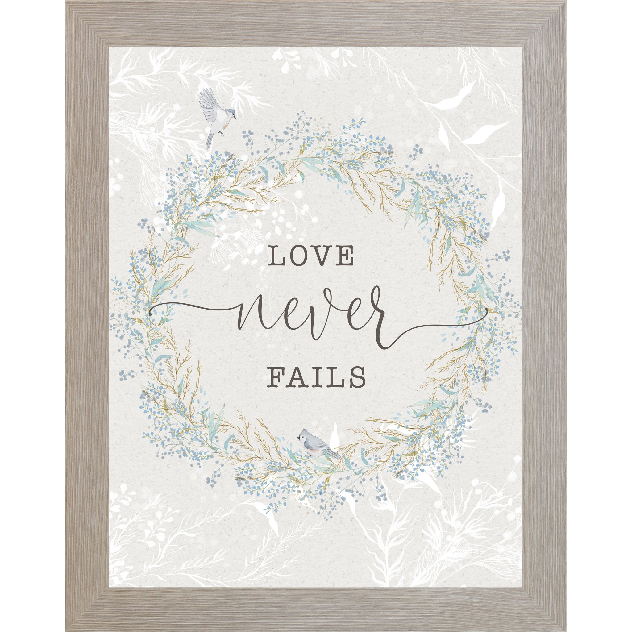 Floral wreath wall art with the words “Love Never Fails” on a soft neutral background.