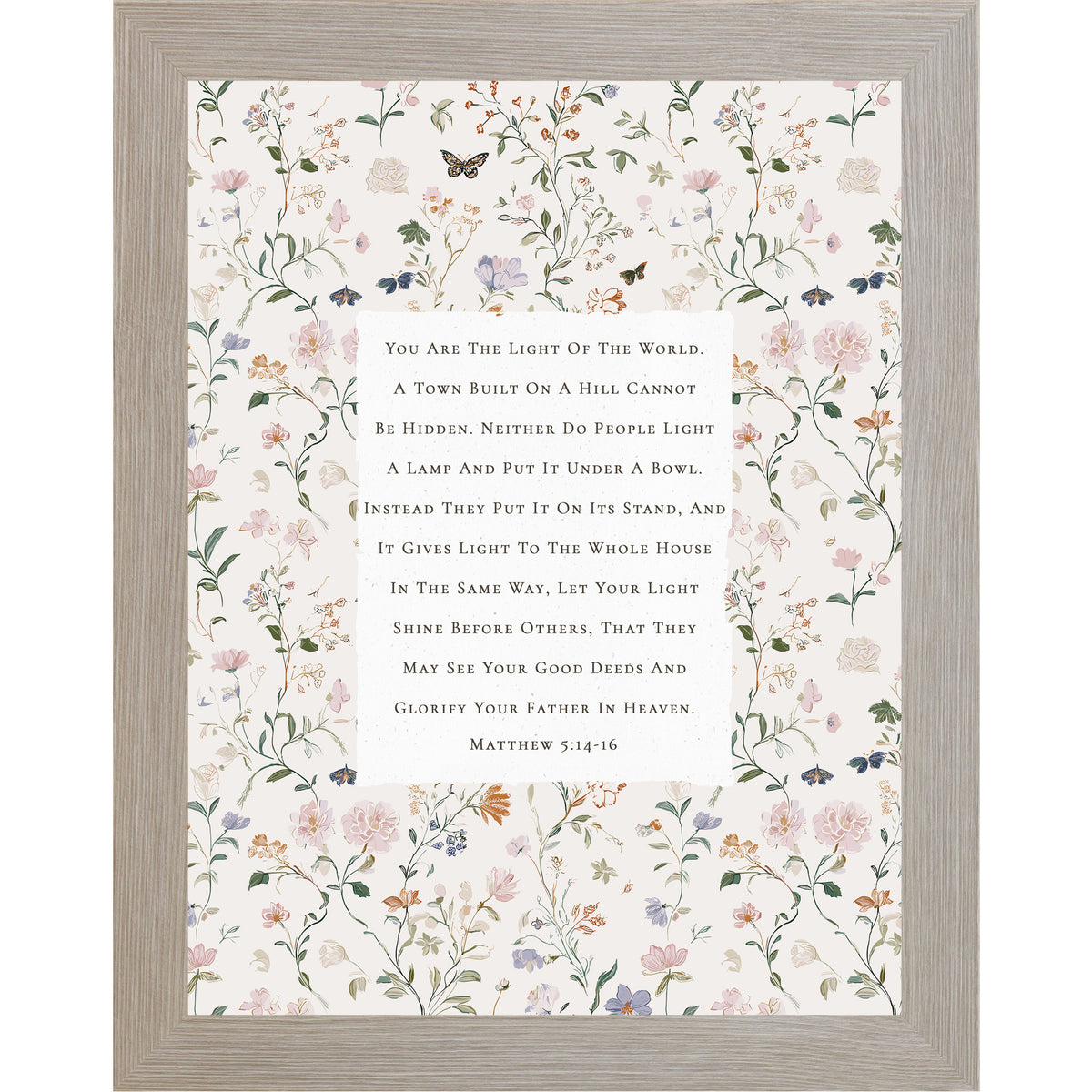 Vertical framed wall art featuring Matthew 5:14-16 Bible verse centered on a neutral background surrounded by soft pastel florals and butterflies, Christian scripture decor in 8x10 and larger sizes.