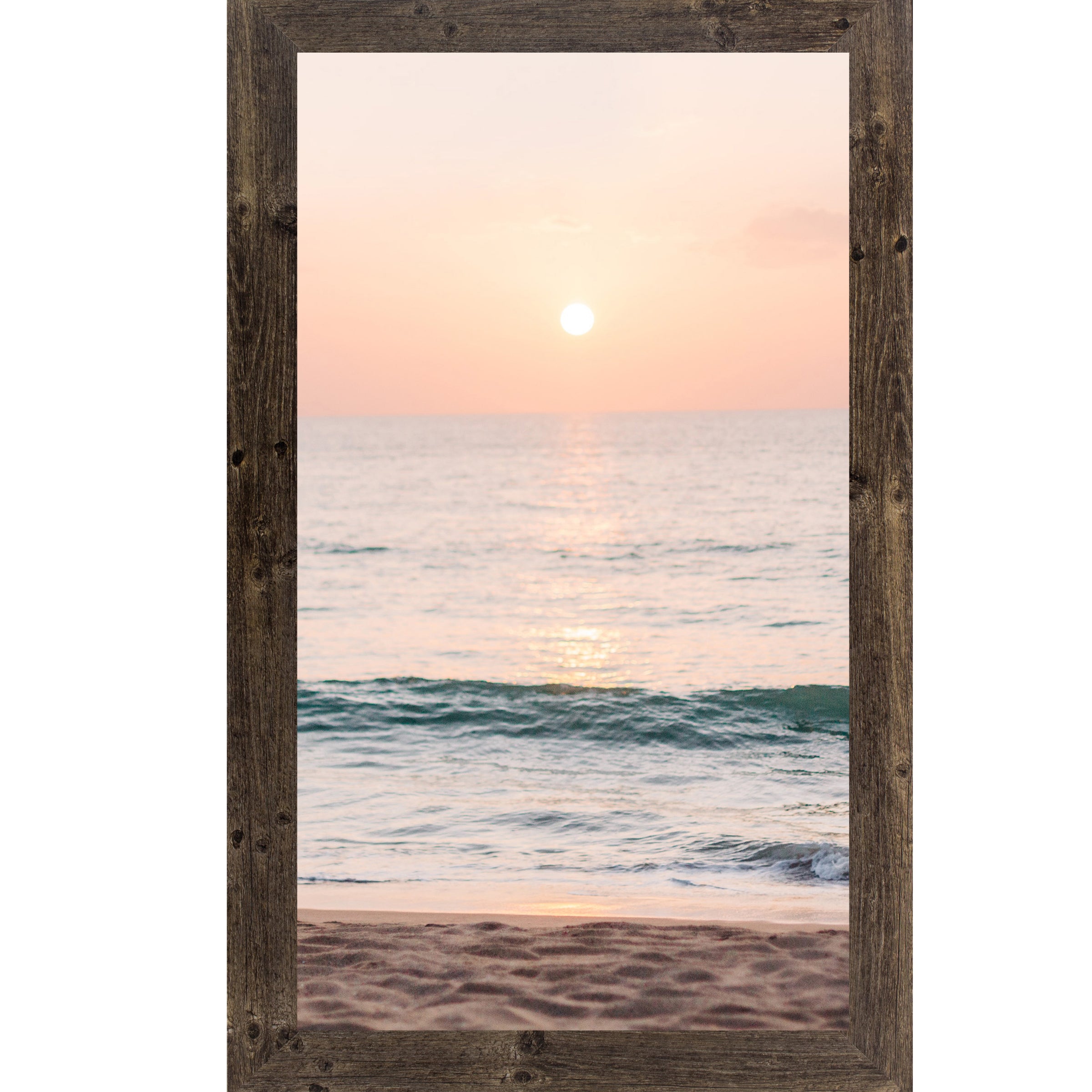 Natural brown framed tall portrait beach sunset wall art featuring a glowing sun above the horizon with soft peach and coral sky, shimmering teal ocean waves, and sandy shoreline