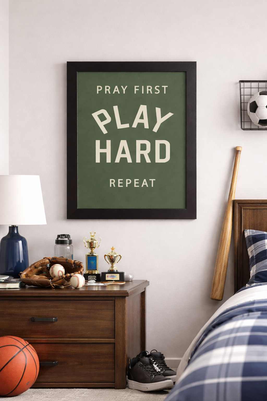 Framed motivational sports wall art with green background reading Pray First Play Hard Repeat for athlete bedroom decor and faith inspired sports spaces. Black Framed In a Kids Room