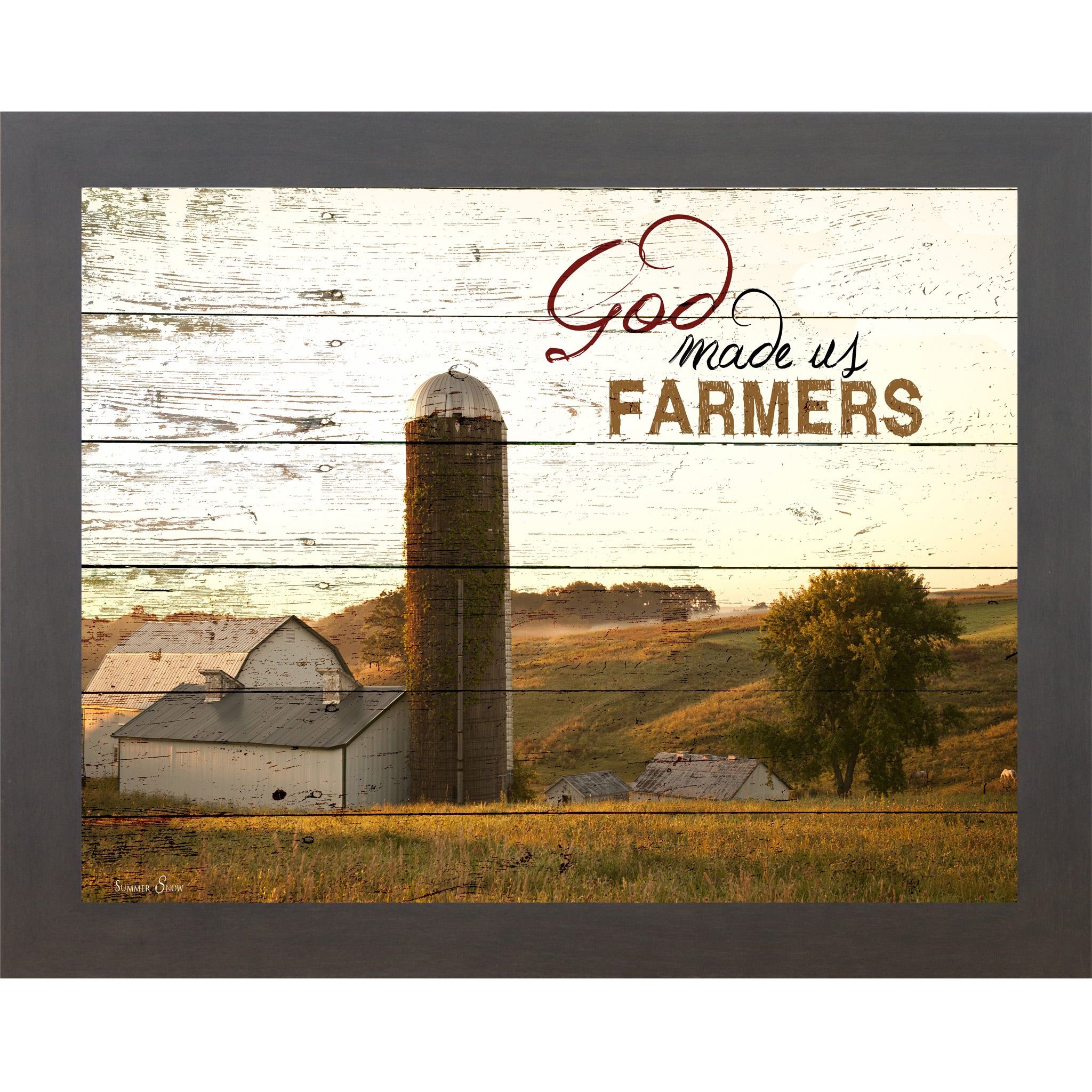 Slatewood framed horizontal farmhouse landscape wall art featuring a white barn and silo on rolling green hills with pallet wood background and the words God Made Us Farmers