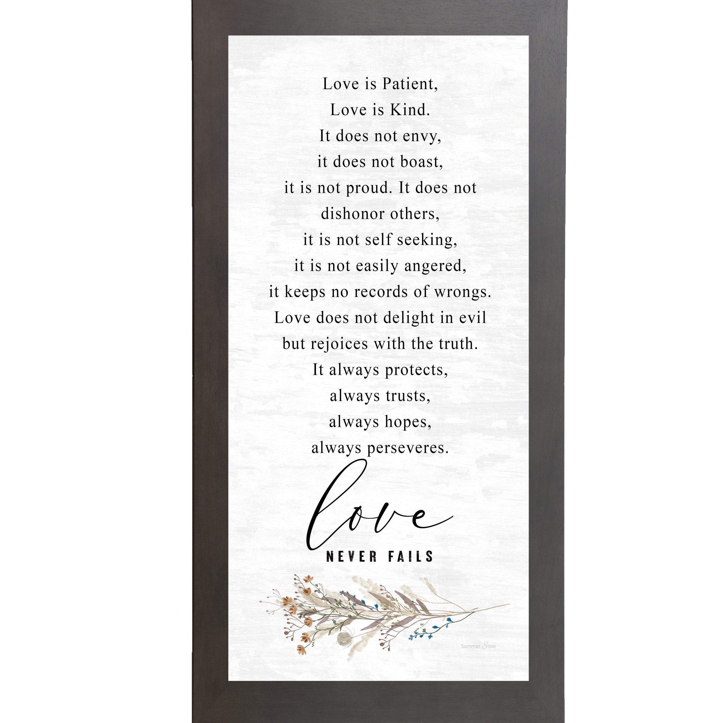 Slatewood framed tall portrait Christian wall art featuring the full 1 Corinthians 13 scripture in elegant serif and flowing script with wildflower botanical sprig and the words "love Never Fails" — SN700