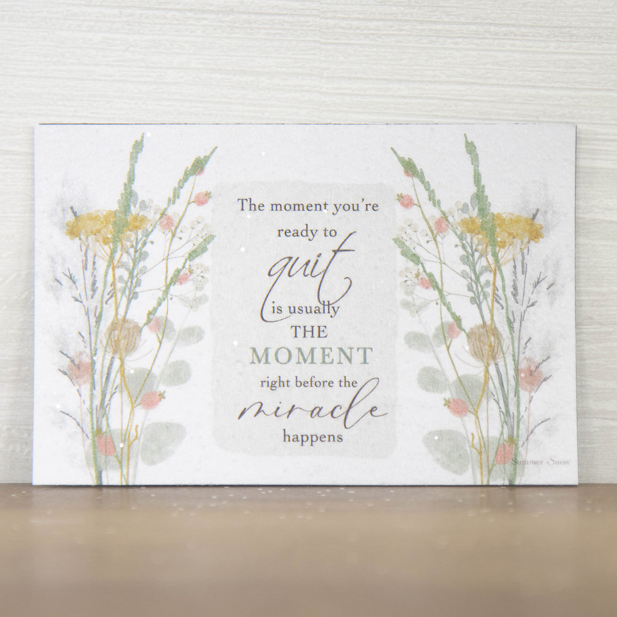 Inspirational encouragement magnet with quote The moment you’re ready to quit is right before the miracle happens, floral accents on both sides with neutral background and subtle glitter finish