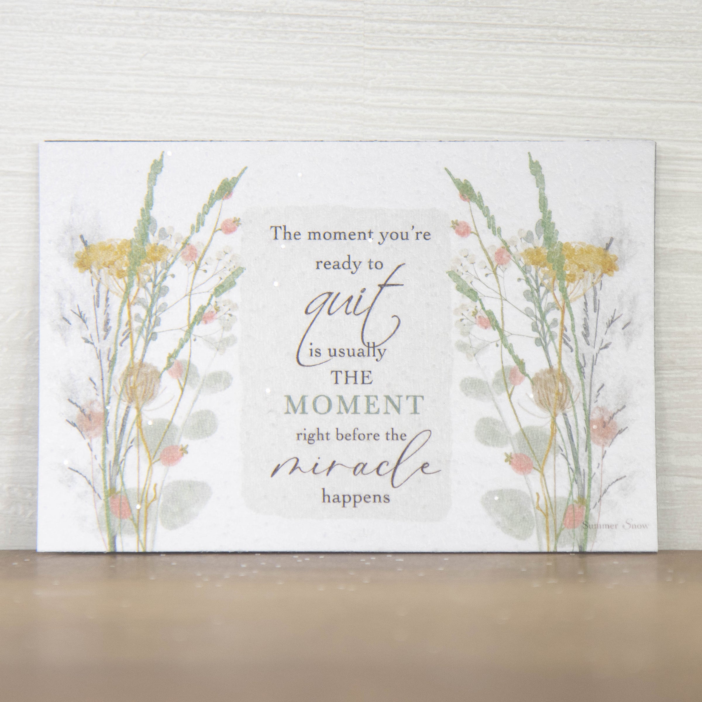 Inspirational encouragement magnet with quote The moment you’re ready to quit is right before the miracle happens, floral accents on both sides with neutral background and subtle glitter finish
