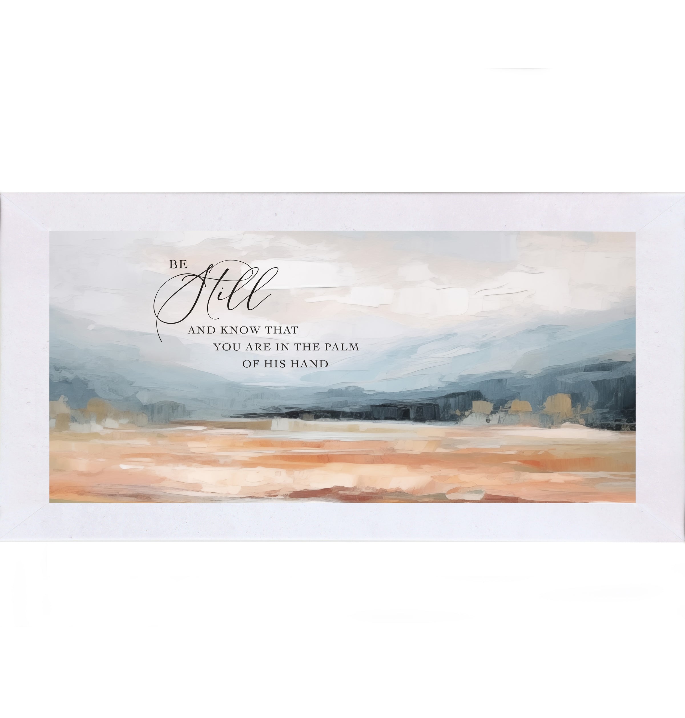 Terracotta White framed wide landscape Christian wall art with Be Still And Know That You Are In The Palm Of His Hand scripture in oversized script over dramatic blue-grey mountains and soft peach blush terracotta field