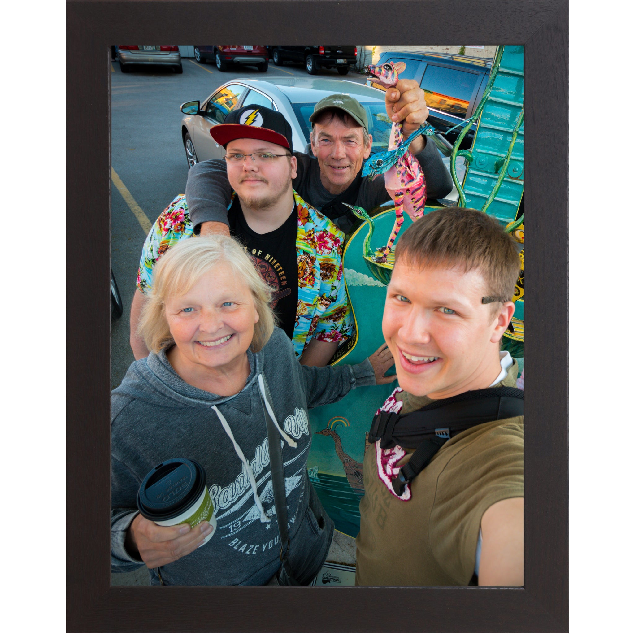Black framed vertical custom photo print showing a professionally framed family photograph in a black 1 inch MDF frame with canvas finish